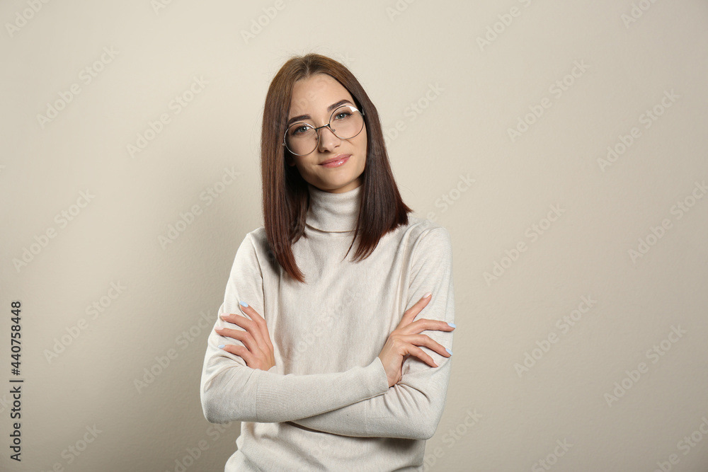 Fototapeta premium Portrait of pretty young woman with gorgeous chestnut hair on light background
