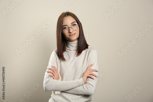 Portrait of pretty young woman with gorgeous chestnut hair on light background