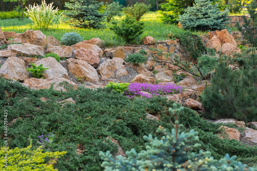 Flowerbeds and trees in the courtyard of a country house Flowerbeds and trees in the courtyard of a country house