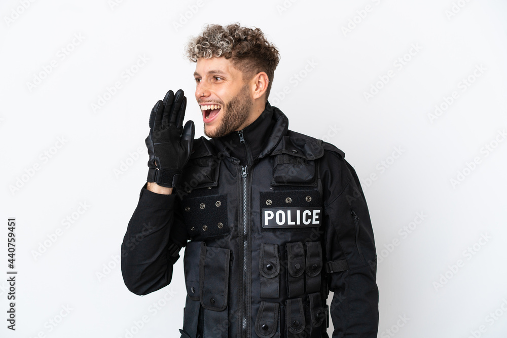 SWAT caucasian man isolated on white background shouting with mouth wide open to the lateral SWAT caucasian man isolated on white background shouting with mouth wide open to the lateral