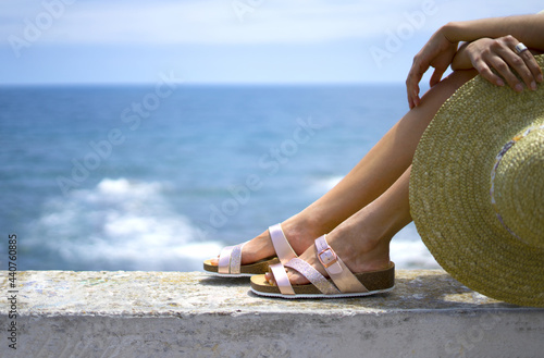 Girl legs in sandals on summer vacation photo