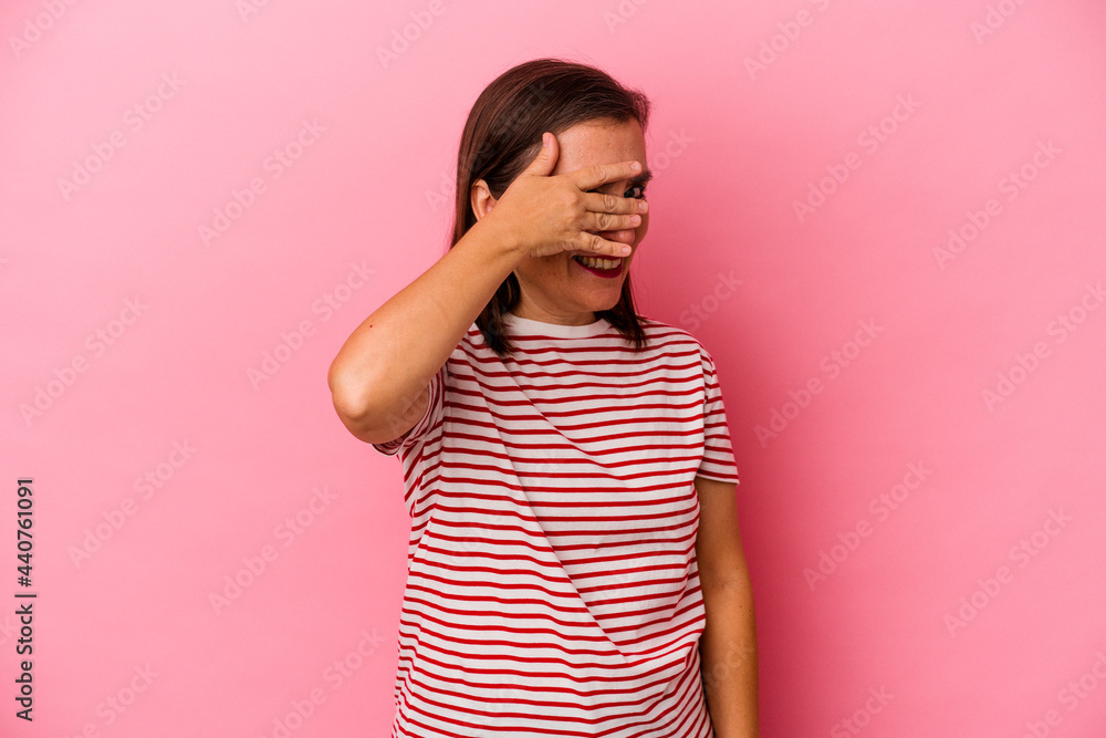 Middle age caucasian woman isolated on pink background covers eyes with hands, smiles broadly waiting for a surprise. Middle age caucasian woman isolated on pink background covers eyes with hands, smiles broadly waiting for a surprise.
