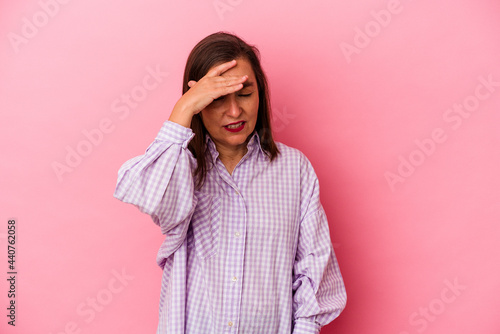 Middle age caucasian woman isolated on pink background touching temples and having headache. © Asier