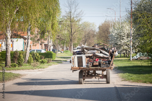 Fototapeta Horse cart full of metal scrap  belonging to the Roma community  to collect garbage to recycle it, in Pancevo, Serbia, in the suburb of Belgrade