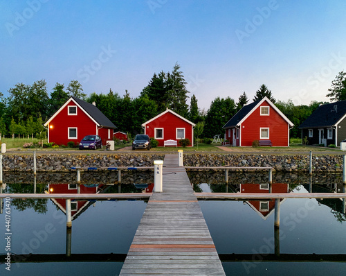 Buying a vacation Home. Red scandinavic houses by the lake. photo