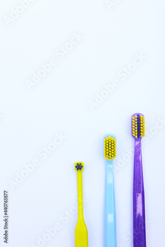 Several toothbrushes for cleaning braces and teeth. Multi-colored toothbrushes. Oral hygiene. Copy space. Top view.Vertical photo.