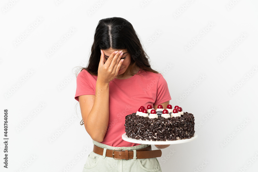 Young caucasian woman holding birthday cake isolated on white background with tired and sick expression Young caucasian woman holding birthday cake isolated on white background with tired and sick expression