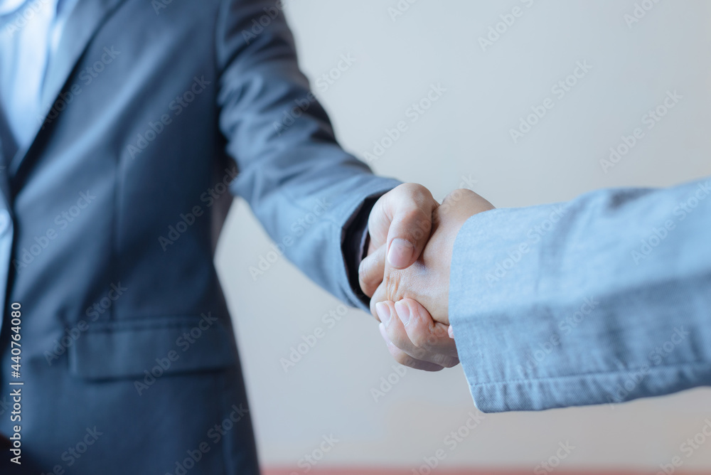 business man and business woman shaking hands for success deal a partnership together. friendship hand shake greeting. business man and business woman shaking hands for success deal a partnership together. friendship hand shake greeting.