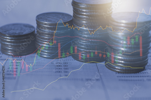 double exposure row of coin stack with growth stock chart and graph progress report for business investment finance banking and money saving concept.