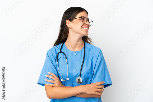 Young surgeon doctor caucasian woman isolated on white background looking side