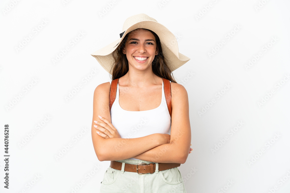 Young caucasian woman wearing a Pamela in summer holidays isolated on white background keeping the arms crossed in frontal position Young caucasian woman wearing a Pamela in summer holidays isolated on white background keeping the arms crossed in frontal position