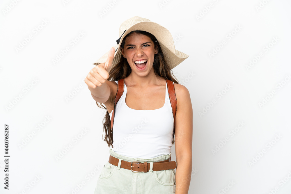 Young caucasian woman wearing a Pamela in summer holidays isolated on white background with thumbs up because something good has happened Young caucasian woman wearing a Pamela in summer holidays isolated on white background with thumbs up because something good has happened