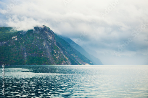 Mountains with clouds on the fjord in Norway. Beautiful summer landscape