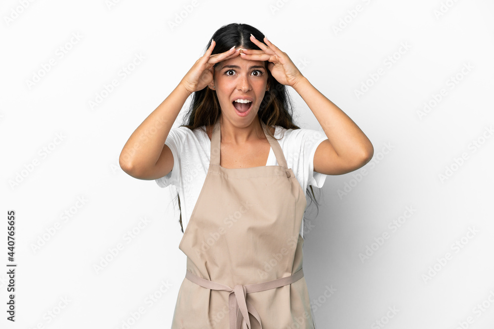 Restaurant waiter over isolated white background with surprise expression Restaurant waiter over isolated white background with surprise expression