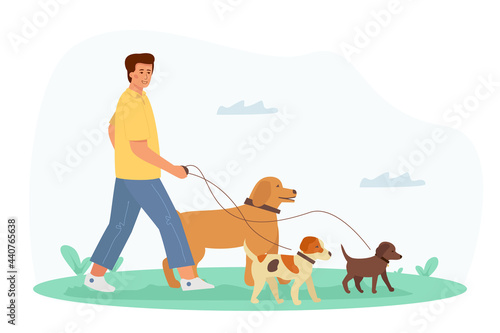 A young handsome man walks with a dog.