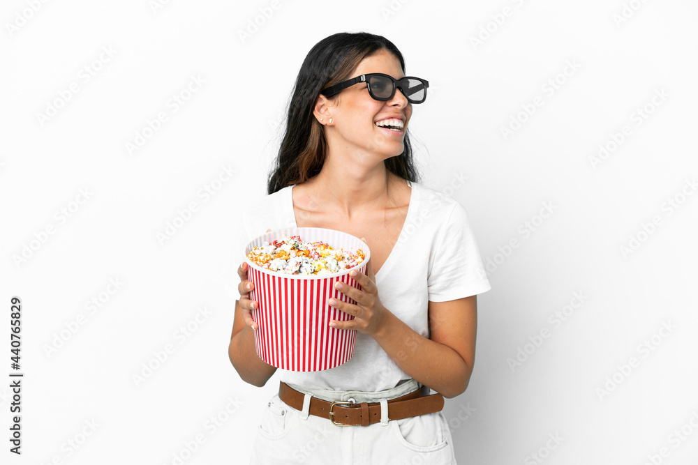 Young caucasian woman isolated on white background with 3d glasses and holding a big bucket of popcorns Young caucasian woman isolated on white background with 3d glasses and holding a big bucket of popcorns