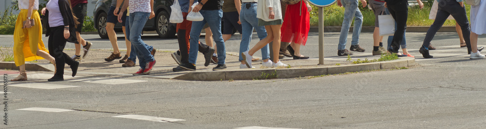 A crowd of pedestrians crossing street in the city, people walking in the street A crowd of pedestrians crossing street in the city, people walking in the street