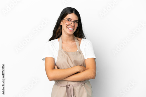 Restaurant waiter over isolated white background with glasses and smiling © luismolinero