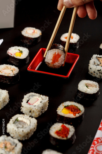 Asian food, uramaki, hot roll, hossomaki and the others a dark stone dish in the restaurant