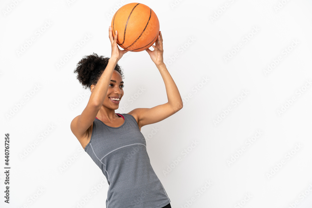 Young basketball player latin woman isolated on white background playing basketball