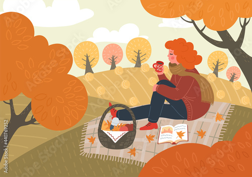 Autumn. Woman reads book and drinks tea, or coffee  outdoors. Fall picnic. Girl sitting on plaid on field or in the park. Rural landscape.