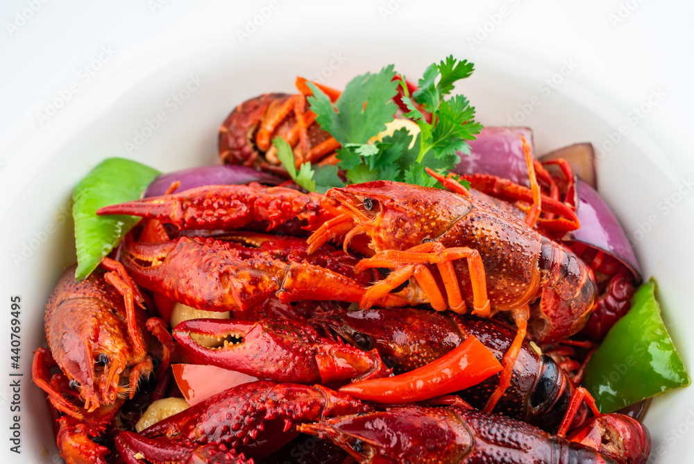 Spicy crayfish in a pot on white background Spicy crayfish in a pot on white background