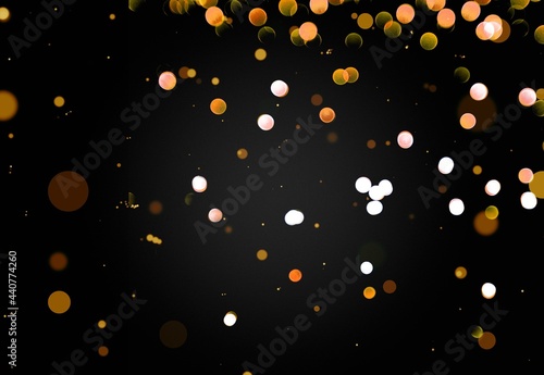 Glittering gold stars of bokeh use for celebrating on a dark background