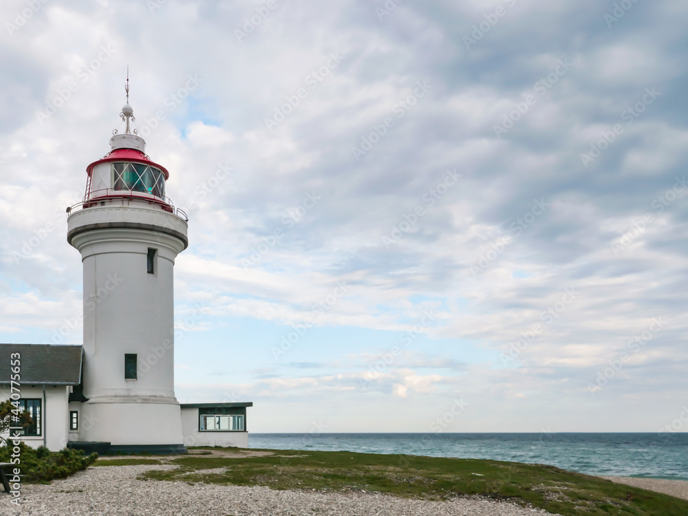 Lighthouse tower on a beach. The Lighthouse - Sletterhage fyr was built in 1894 and is still working in Denmark today