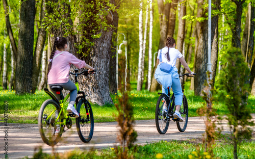 Cyclists ride on the bike path in the city Park