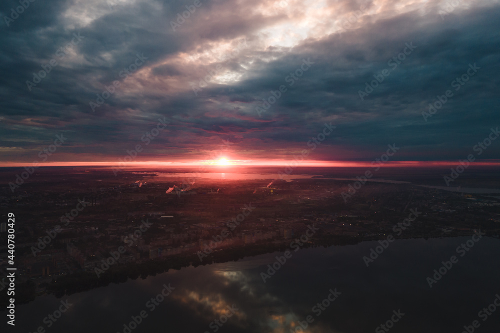 Aerial drone filmed the sunset, burning sky over the city and water.Beautiful sunset or sunrise.  Panoramic view