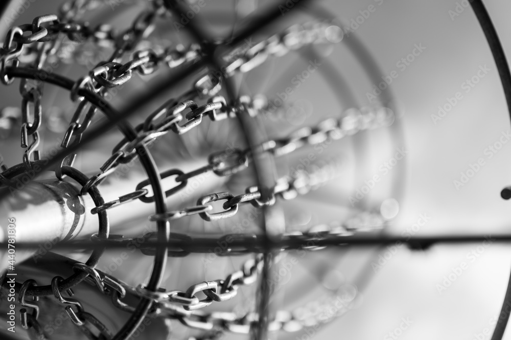 Underneath a disc golf goal looking up with selective focus on the chain basket. Underneath a disc golf goal looking up with selective focus on the chain basket.