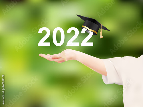 Schoolgirl outstretched hand with Class of 2022 with graduation cap on green nature background. The concept of designing congratulations for graduates of the school. Vector in realistic style