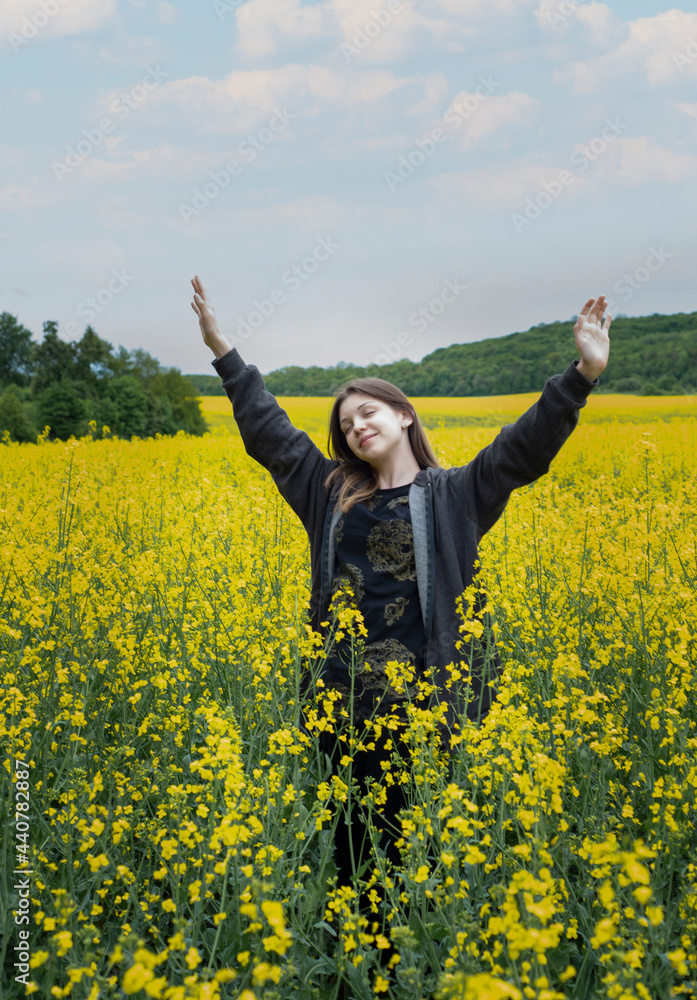 Young girl on yellow rapeseed field Young girl on yellow rapeseed field