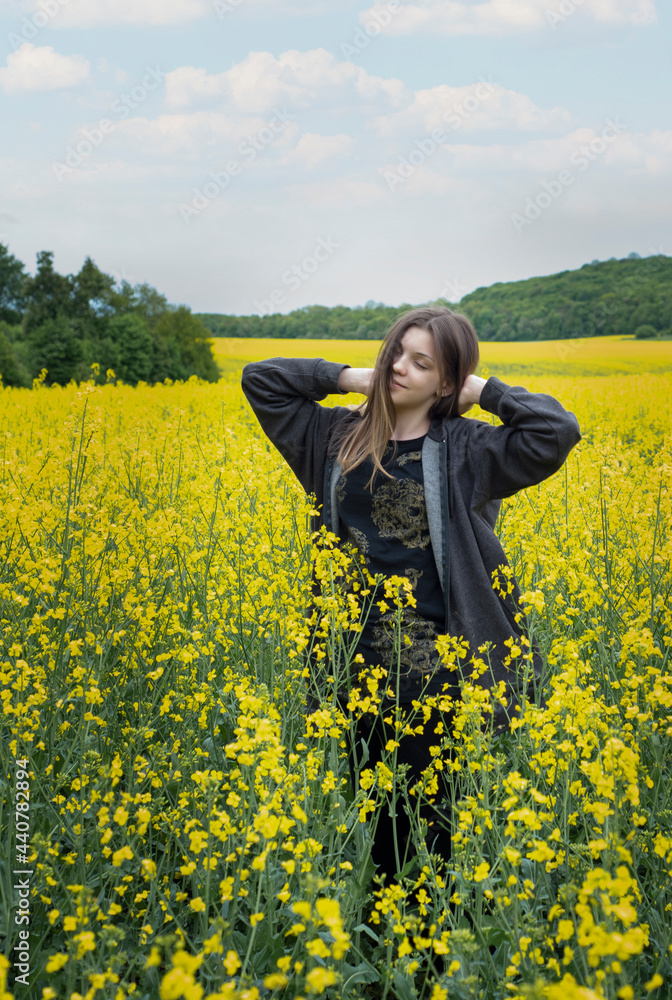 Young girl on yellow rapeseed field Young girl on yellow rapeseed field