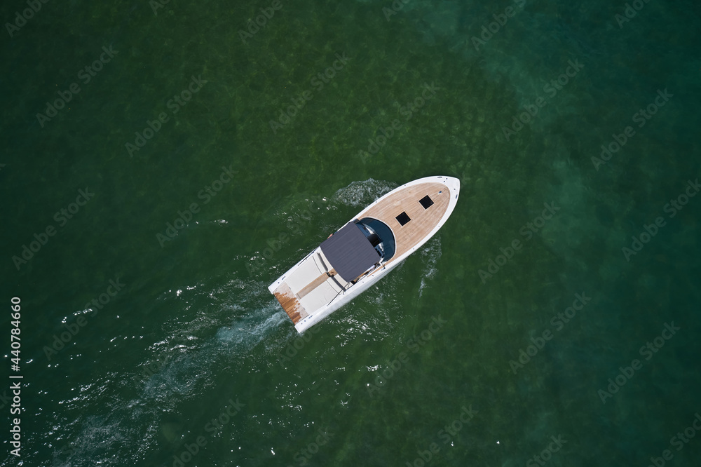 Motor boat top view. Aerial view of a boat in slow motion turquoise water. Motor boat top view. Aerial view of a boat in slow motion turquoise water.