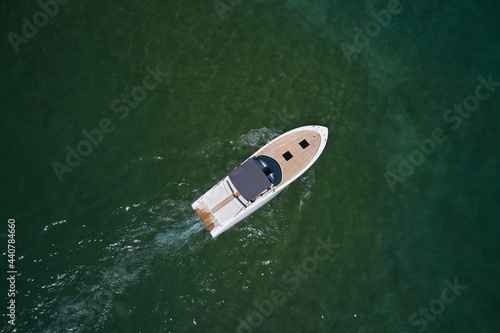 Motor boat top view. Aerial view of a boat in slow motion turquoise water.