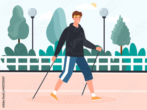 Young man doing nordic walking outdoors