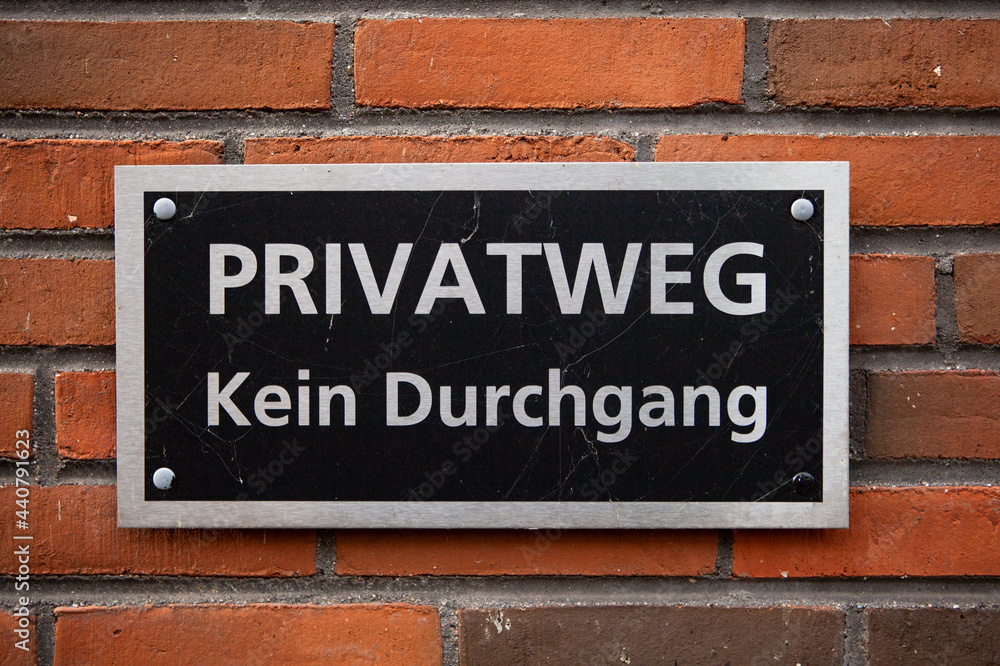The photo shows a sign indicating a private way on a house wall The photo shows a sign indicating a private way on a house wall