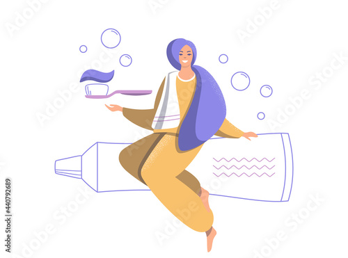 Smiling woman with a toothbrush and toothpaste.