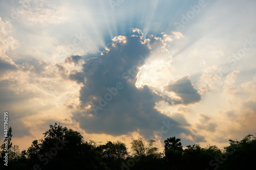 Divine glow through the clouds of the evening warm sun. Rays of light shining down on sky.