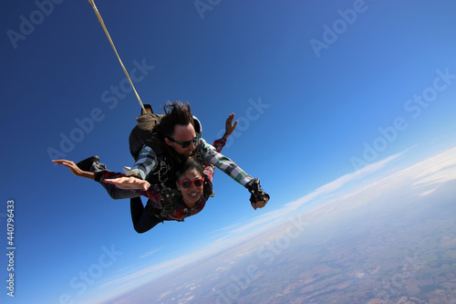 Tandem parachute jump. Beautiful Brazilian woman.