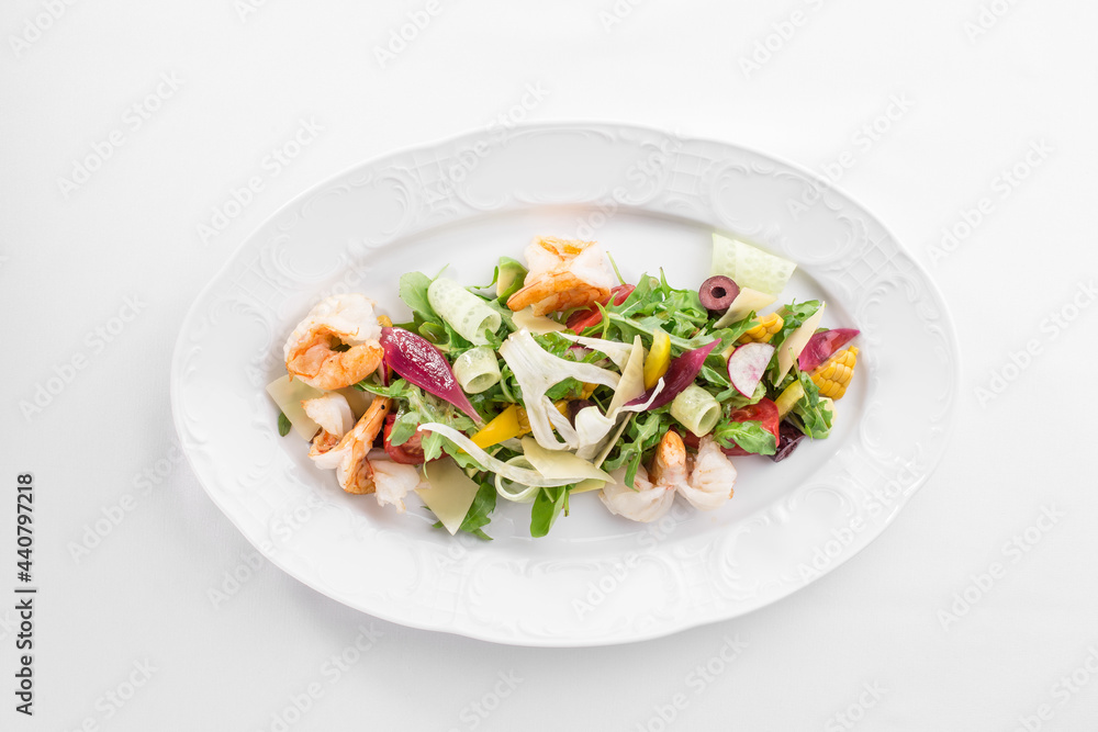 Shrimp salad with avocado and tomatoes on white plate isolated on white background Shrimp salad with avocado and tomatoes on white plate isolated on white background