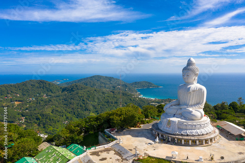 aerial photography Phuket big Buddha in sunny day.Phuket Big Buddha is one of the most important and revered landmarks on Phuket island..white cloud in blue sky, blue sea and mountain background © Narong Niemhom