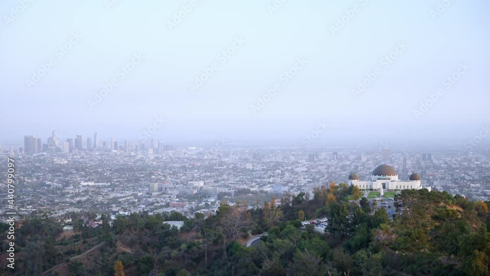 Scenic view of the Griffith Observatory Park and cityscape in Los Angeles from the mountains Scenic view of the Griffith Observatory Park and cityscape in Los Angeles from the mountains