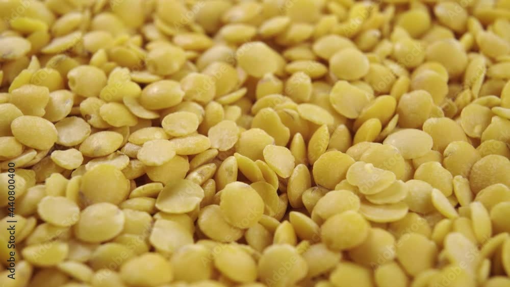 Raw yellow lentil seeds. Macro shot. Rotation. Uncooked legumes. Healthy food concept Raw yellow lentil seeds. Macro shot. Rotation. Uncooked legumes. Healthy food concept