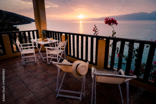 table and chairs with breakfast during sunrise at the meditarian sea in Greece. High quality photo photo