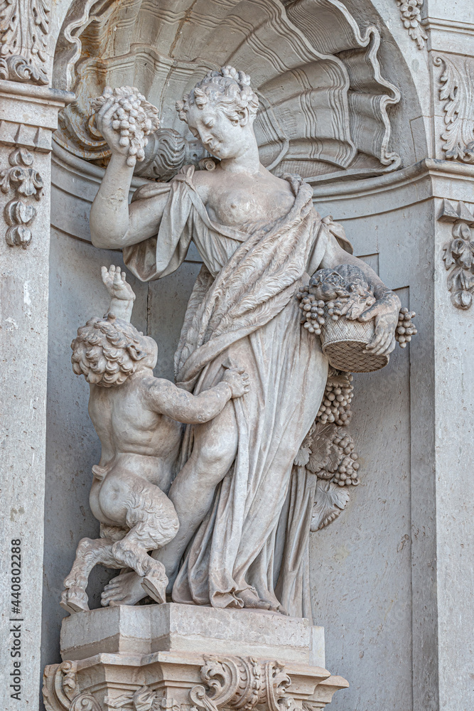 Old statue of a sensual Baroque Era woman in downtown of Dresden, Germany, details, closeup.