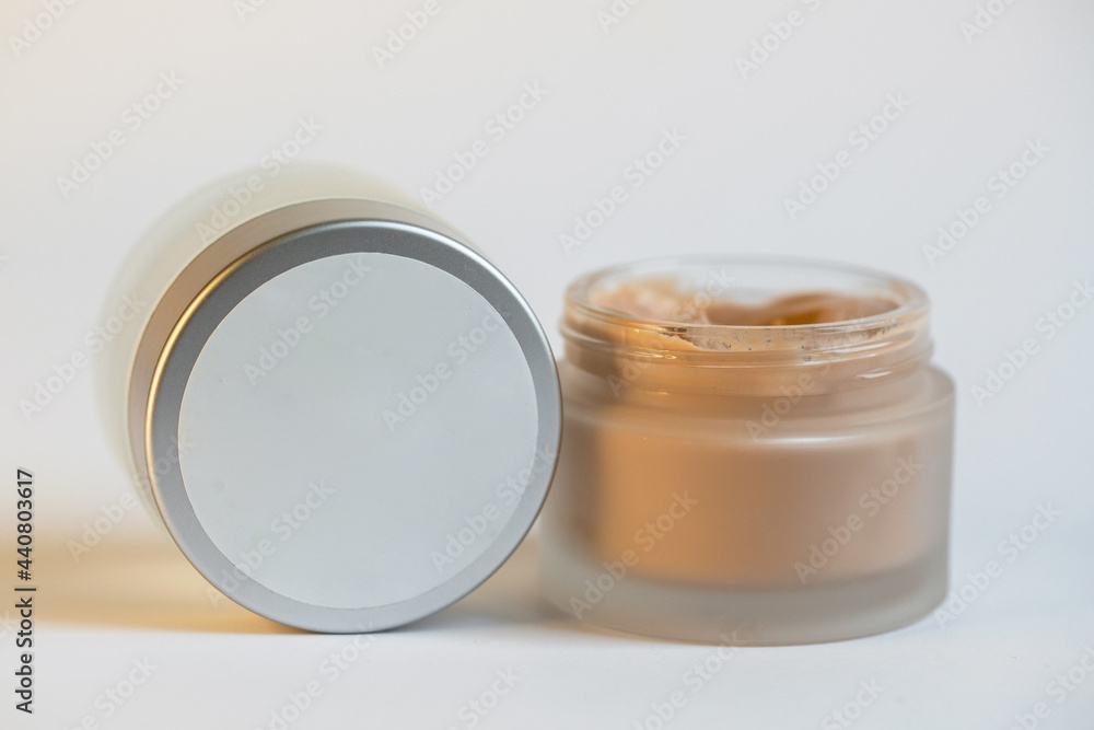 Cream in a jar on a white background Cream in a jar on a white background