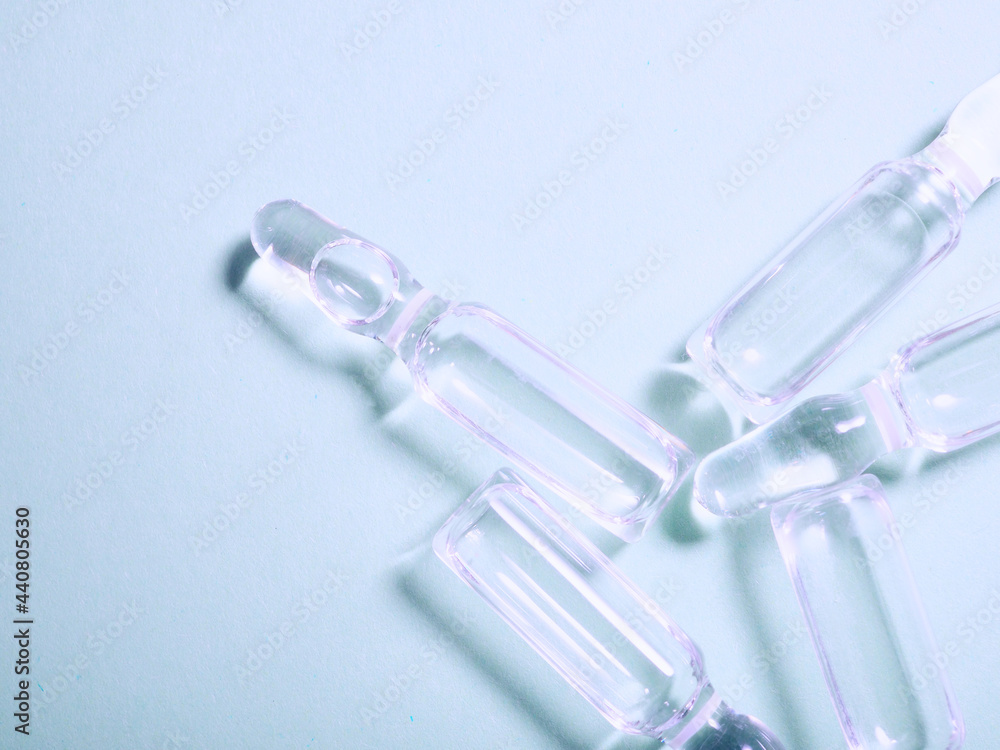 Production of medicines. lot of ampoules. Ampoules on the table. Glass ampoules close up. Ampoules lying on the table with medicine. Production of medicines. lot of ampoules. Ampoules on the table. Glass ampoules close up. Ampoules lying on the table with medicine.