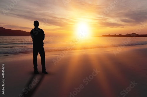 Man relaxing on the beautiful beach at sunset.